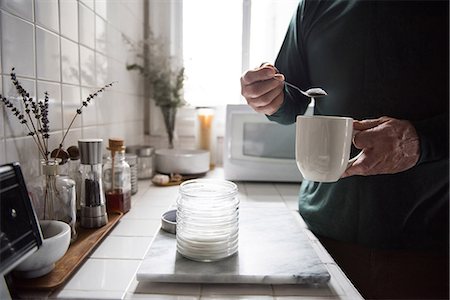 drink black coffee - Mid-section of man preparing a black coffee in kitchen at home Stock Photo - Premium Royalty-Free, Code: 6109-08805010