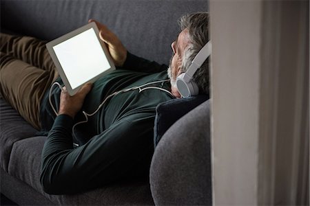 simsearch:6109-08944589,k - Man listening music on digital tablet at home Stock Photo - Premium Royalty-Free, Code: 6109-08805015