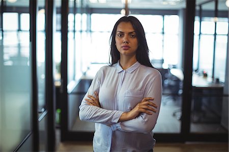 simsearch:6109-08805120,k - Portrait of businesswoman standing with arms crossed in office Stock Photo - Premium Royalty-Free, Code: 6109-08805034