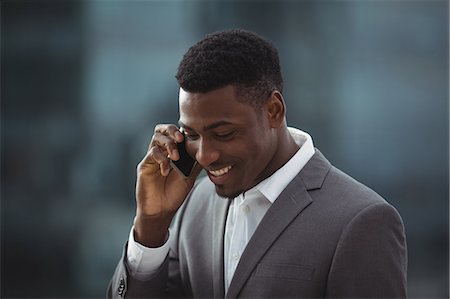 simsearch:693-08769289,k - Businessman talking on mobile phone on office terrace Stock Photo - Premium Royalty-Free, Code: 6109-08805117