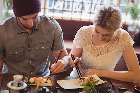 delicious food table pictures white - Couple eating sushi Stock Photo - Premium Royalty-Free, Code: 6109-08829504