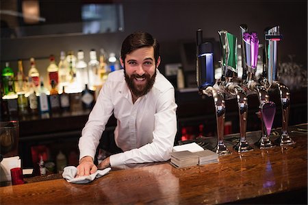 Portrait of bartender cleaning bar counter Stock Photo - Premium Royalty-Free, Code: 6109-08829849