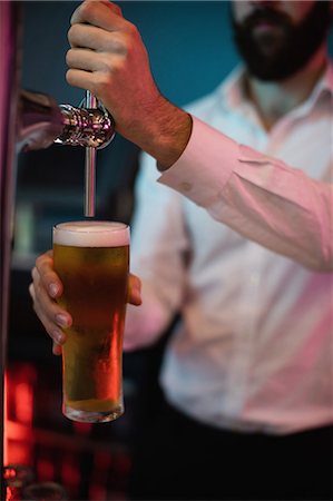 focused on people - Bartender filling beer from bar pump Stock Photo - Premium Royalty-Free, Code: 6109-08829854