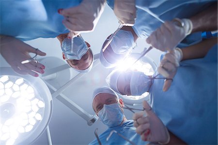 simsearch:6109-08389797,k - Group of surgeons performing operation in operation room Stock Photo - Premium Royalty-Free, Code: 6109-08829999