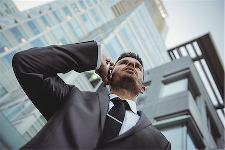 simsearch:6109-08763979,k - Businessman talking on the mobile phone Stock Photo - Premium Royalty-Free, Code: 6109-08830058