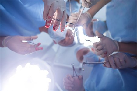 simsearch:6109-08389797,k - Group of surgeons performing operation in operation room Stock Photo - Premium Royalty-Free, Code: 6109-08830000
