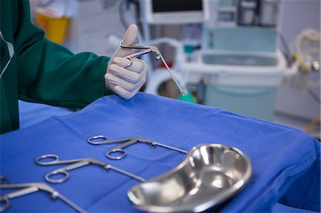 surgery tray - Surgeons performing operation in operation room Stock Photo - Premium Royalty-Free, Code: 6109-08830161