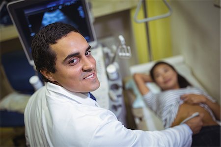 Female patient receiving a ultrasound scan on the stomach Stock Photo - Premium Royalty-Free, Code: 6109-08830180