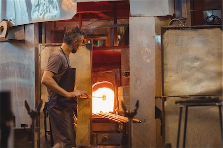 simsearch:400-06796868,k - Glassblower heating a glass in glassblowers oven Stock Photo - Premium Royalty-Free, Code: 6109-08830189