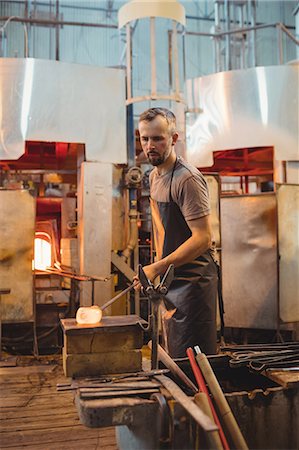 simsearch:614-06973581,k - Glassblower shaping a molten glass on marver table Stock Photo - Premium Royalty-Free, Code: 6109-08830195