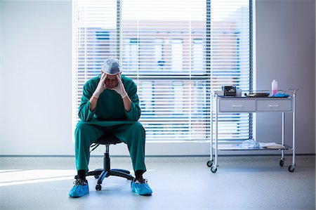 simsearch:6109-08689539,k - Tensed surgeon sitting on a chair Stock Photo - Premium Royalty-Free, Code: 6109-08830119
