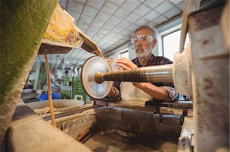 Glassblower polishing and grinding a glassware Stock Photo - Premium Royalty-Free, Code: 6109-08830283