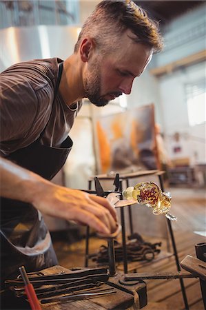 focused artisan - Glassblower shaping a molten glass Stock Photo - Premium Royalty-Free, Code: 6109-08830208