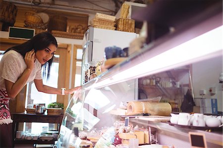 dairy store - Woman looking at food display Stock Photo - Premium Royalty-Free, Code: 6109-08830393