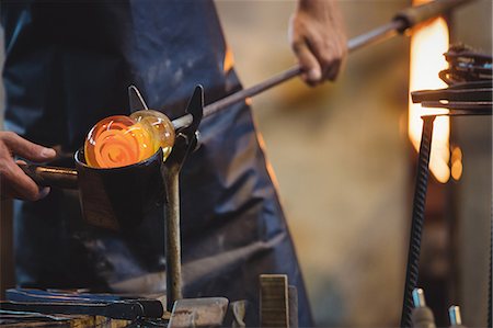 simsearch:6118-08729041,k - Glassblower forming and shaping a molten glass Stock Photo - Premium Royalty-Free, Code: 6109-08830315
