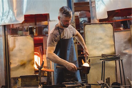 simsearch:614-08821251,k - Glassblower forming and shaping a molten glass Stock Photo - Premium Royalty-Free, Code: 6109-08830325