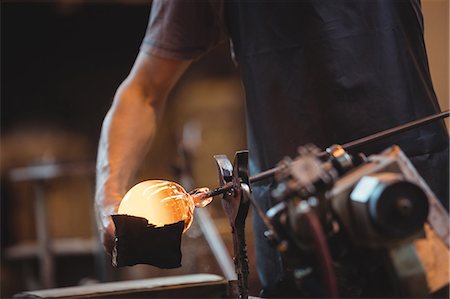 simsearch:6118-08729041,k - Glassblower forming and shaping a molten glass Stock Photo - Premium Royalty-Free, Code: 6109-08830334