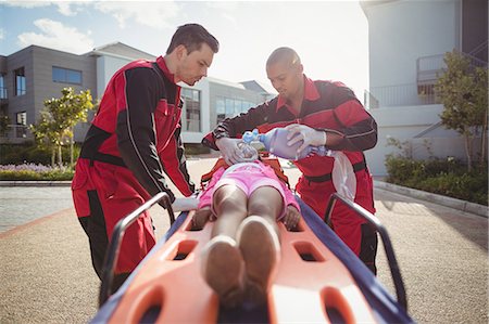 Paramedic giving oxygen to injured girl Stock Photo - Premium Royalty-Free, Code: 6109-08830447