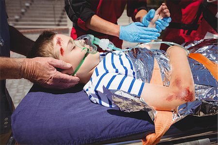 simsearch:6109-08830452,k - Paramedics examining injured boy Stock Photo - Premium Royalty-Free, Code: 6109-08830425