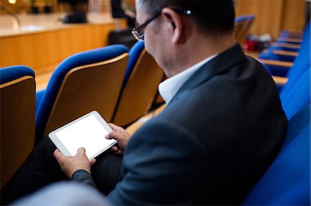 simsearch:6109-08830515,k - Business executive participating in a business meeting using digital tablet Photographie de stock - Premium Libres de Droits, Code: 6109-08830521