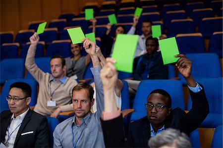 Business executives show their approval by raising hands Stock Photo - Premium Royalty-Free, Code: 6109-08830527