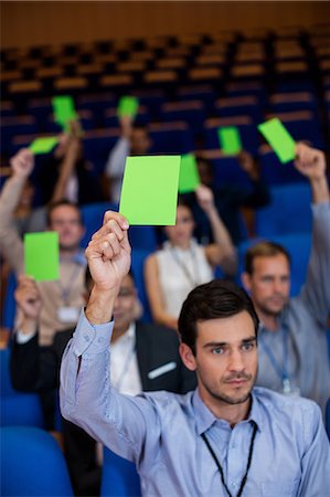 Business executives show their approval by raising hands Stock Photo - Premium Royalty-Free, Code: 6109-08830525