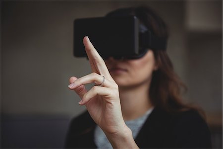 futuristic joy - Business executive using virtual reality headset Stock Photo - Premium Royalty-Free, Code: 6109-08830743