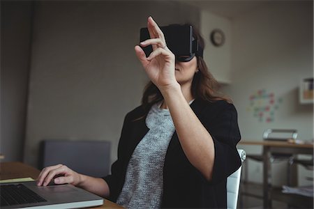 futuristic offices - Business executive using virtual reality headset Stock Photo - Premium Royalty-Free, Code: 6109-08830744