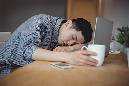 simsearch:6102-08168824,k - Business executive sleeping at his desk Stock Photo - Premium Royalty-Free, Code: 6109-08830756