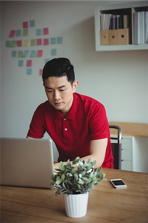 surfing the net - Business executive working on laptop Stock Photo - Premium Royalty-Free, Code: 6109-08830772