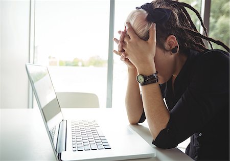 simsearch:400-05209351,k - Stressed woman using laptop in café Stock Photo - Premium Royalty-Free, Code: 6109-08944177