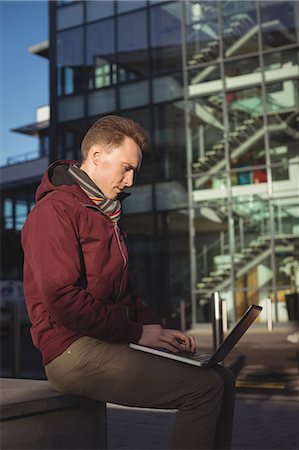 Male executive using laptop in office premise Stock Photo - Premium Royalty-Free, Code: 6109-08944263