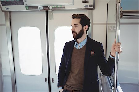 Young businessman travelling in train Stock Photo - Premium Royalty-Free, Code: 6109-08944216