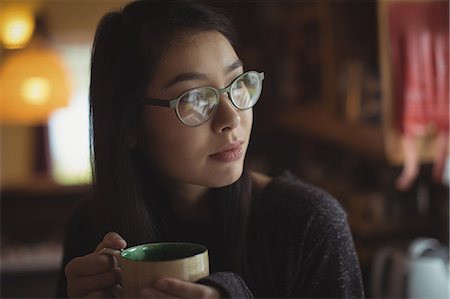 simsearch:6109-08953348,k - Thoughtful woman having coffee in kitchen at home Stock Photo - Premium Royalty-Free, Code: 6109-08944343