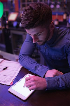 restaurant owner tablet - Bartender using digital tablet at counter in bar Stock Photo - Premium Royalty-Free, Code: 6109-08944464