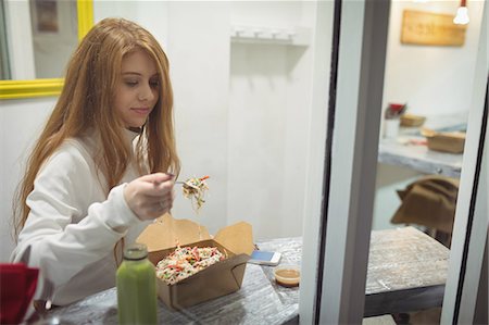 simsearch:649-06352854,k - Beautiful woman eating salad in the restaurant Stock Photo - Premium Royalty-Free, Code: 6109-08944416