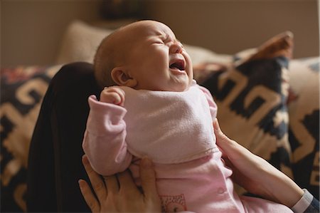 simsearch:6109-08944518,k - Close-up of mother consoling her crying baby in living room at home Fotografie stock - Premium Royalty-Free, Codice: 6109-08944569