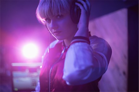 deejay (female) - Portrait of female dj listening to music in headphones at bar Stock Photo - Premium Royalty-Free, Code: 6109-08944502