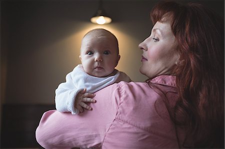 simsearch:6109-08944514,k - Mother holding her cute baby in arms at café Foto de stock - Sin royalties Premium, Código: 6109-08944507