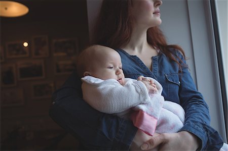 simsearch:6109-08944514,k - Mother holding her cute baby in arms at café Foto de stock - Sin royalties Premium, Código: 6109-08944515