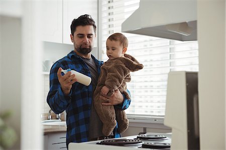 simsearch:6109-08944679,k - Father preparing milk for his baby in kitchen at home Stock Photo - Premium Royalty-Free, Code: 6109-08944738