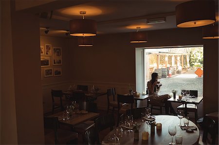 reflection in restaurant window - Thoughtful woman having cup of coffee near window at café Stock Photo - Premium Royalty-Free, Code: 6109-08944958