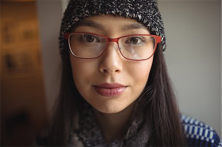 specs - Portrait of beautiful woman wearing cap and spectacles in cafe Stock Photo - Premium Royalty-Free, Code: 6109-08944965