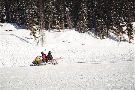 people on snowmobiles - Skiers riding snowmobile in snowy alps during winter Stock Photo - Premium Royalty-Free, Code: 6109-08944915