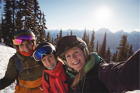 simsearch:6109-08944908,k - Portrait of three female skiers standing together on snow covered mountain Stock Photo - Premium Royalty-Free, Code: 6109-08944919
