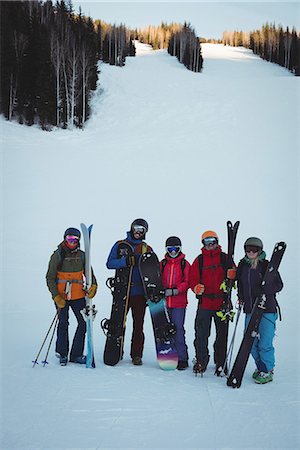 simsearch:6109-06195607,k - Group of skiers with skies standing on snowy landscape in ski resort Photographie de stock - Premium Libres de Droits, Code: 6109-08944924