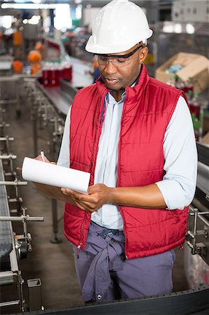 Confident male employee noting about products in juice factory Stock Photo - Premium Royalty-Free, Code: 6109-08945149