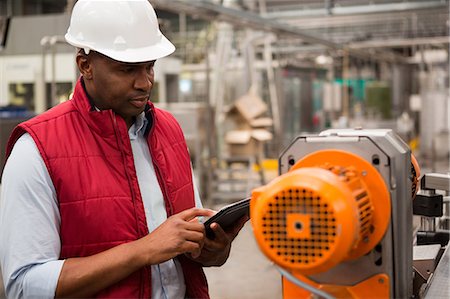 Confident male employee using digital tablet in juice factory Stock Photo - Premium Royalty-Free, Code: 6109-08945155