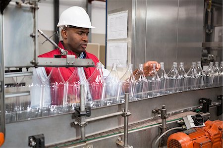 simsearch:6109-08945072,k - Confident male employee examining bottles in juice factory Stock Photo - Premium Royalty-Free, Code: 6109-08945161