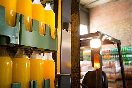 Yellow juice bottles arranged on forklift in warehouse Stock Photo - Premium Royalty-Free, Code: 6109-08945121